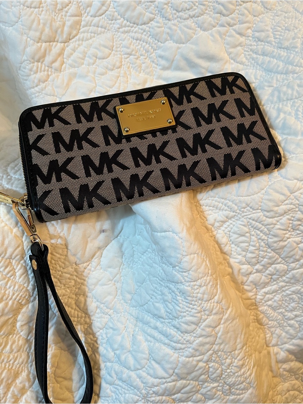 Michael Kors Black Logo Zip Wristlet with Tan Background